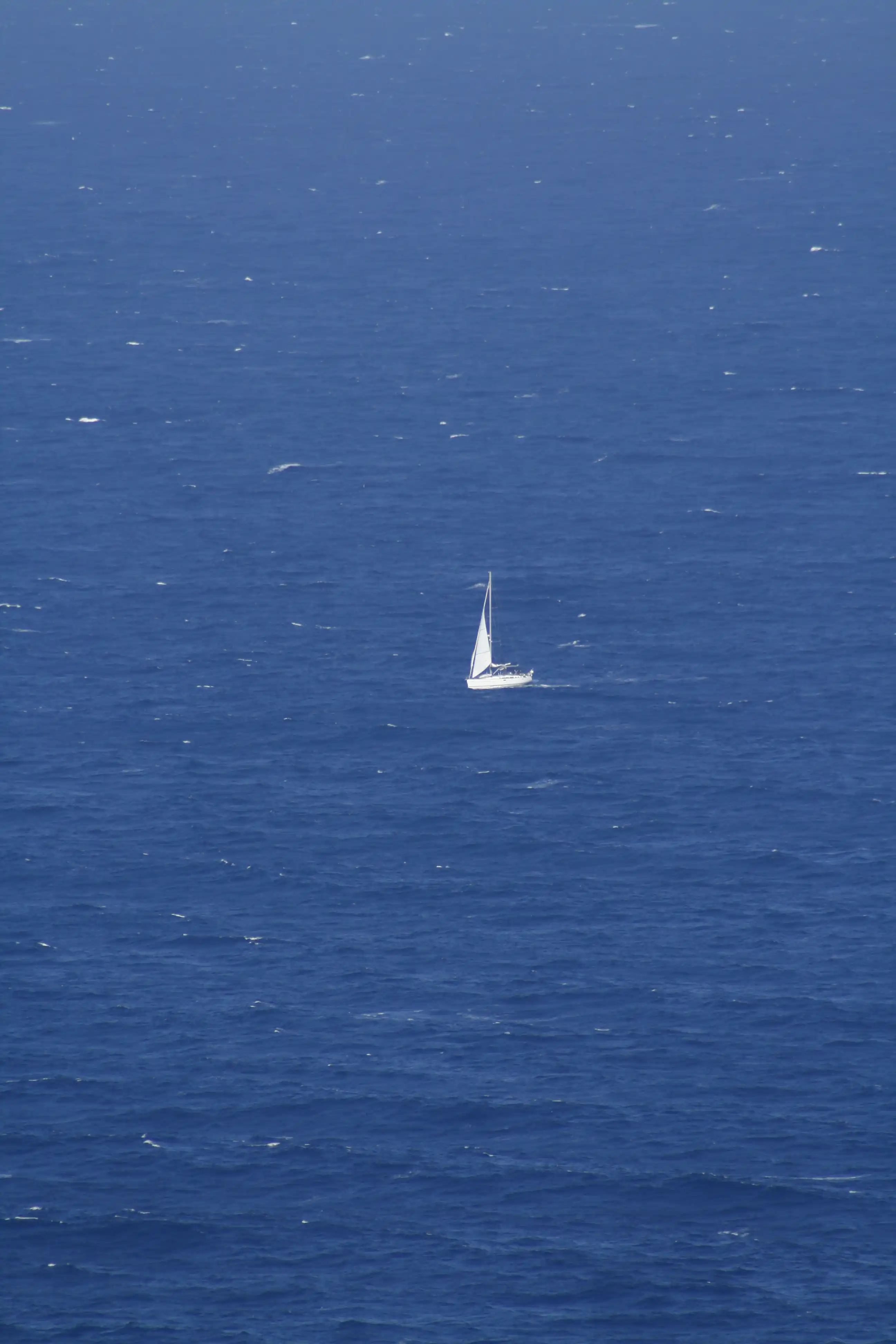 White boat on the blue sea in Greece – fine art photography by Jan Maghreb